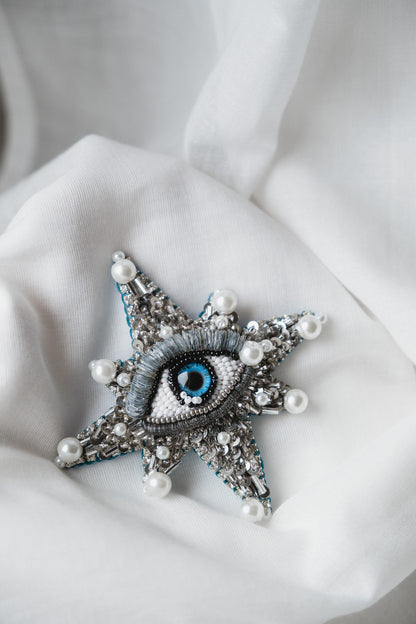 Symbolic eye brooch