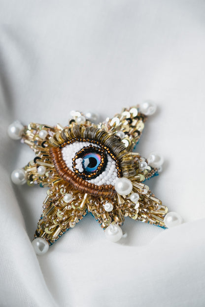 Symbolic eye brooch